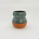 Ceramic vase with two-tone design on a white background