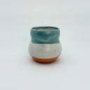 Ceramic cup with a two-tone design on a white background