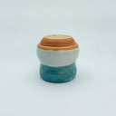 Ceramic container with a brown base on a white background