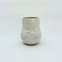 White ceramic vase with sculpted hand patterns on a white background