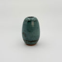 Green ceramic vase on a white background
