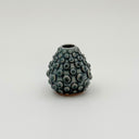 Kleybird Dotty bud vase with blue glaze and raised texture.