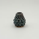 Kleybird Dotty bud vase with blue glaze and raised texture.