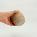 Kleybird Strata handleless tumbler with marbled clay exterior and light aqua interior held in hand.
