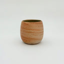 Kleybird Strata handleless tumbler with marbled clay exterior and light aqua interior.
