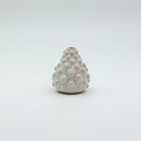 Small pear-shaped white ceramic vase with raised dot texture from the Kleybird Mini collection, held in a hand for scale.