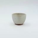 Small square-rimmed ceramic cup with speckled white glaze
