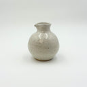 Glossy speckled white ceramic pouring jug with a small spout